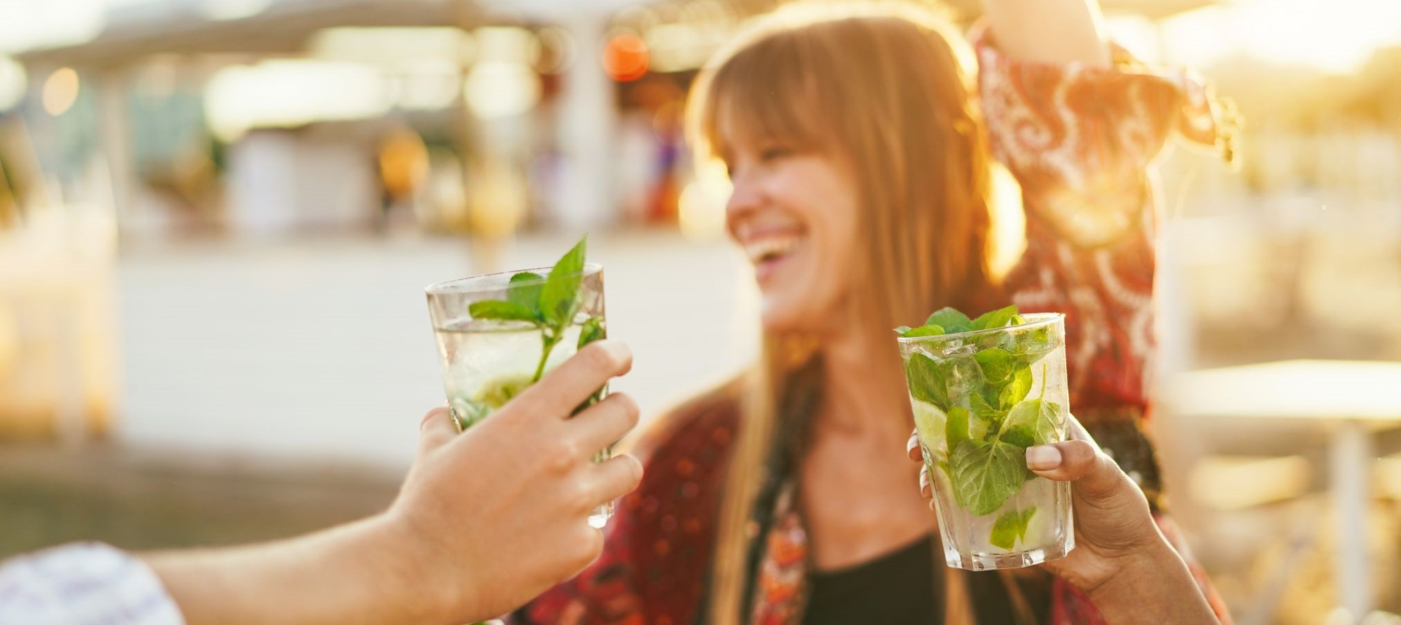 Woman enjoying drink on beach